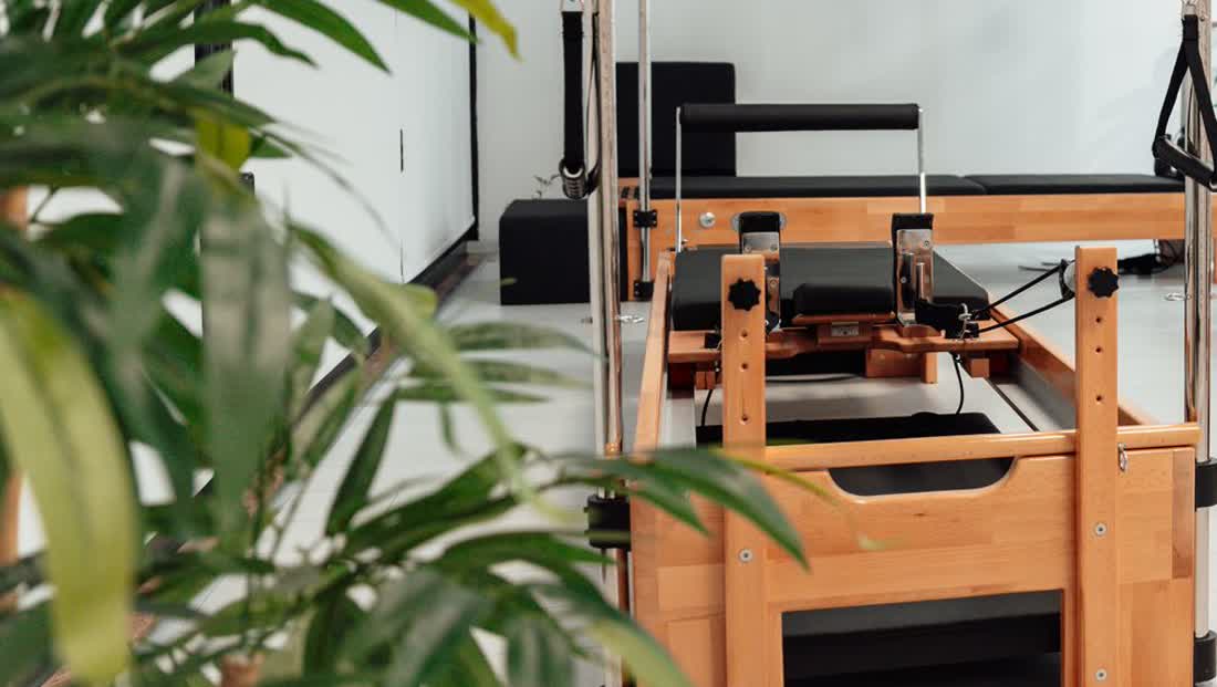 Kelly mid-stretch on a reformer at a Balanced Body training center