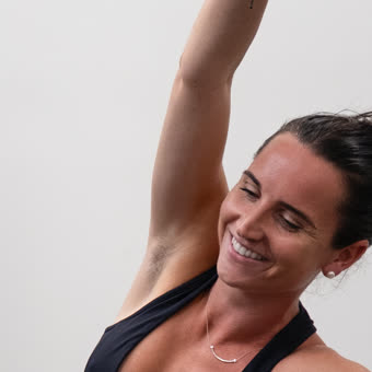 Kelly Stevenson, smiling mid-stretch
